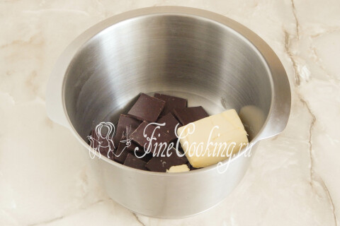 Кусочки тёмного шоколада и сливочное масло в миске для растапливания на водяной бане