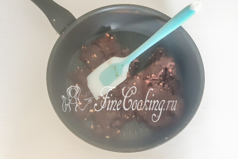 Шоколадная масса с манкой и орехами, перемешанная в сковороде до однородности.