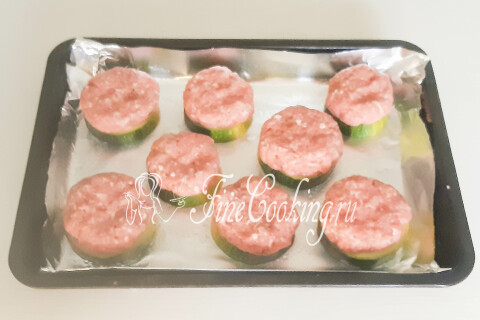 Круглые котлеты из фарша, уложенные поверх кабачковых кружочков.