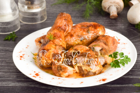Куриные ножки, фаршированные грибами и сыром, на тарелке с гарниром