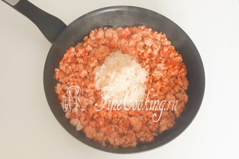 Промытый рис всыпан в сковороду поверх фарша с овощами.