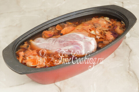 Свиная рулька, погружённая в кипящий рассол с луковой шелухой